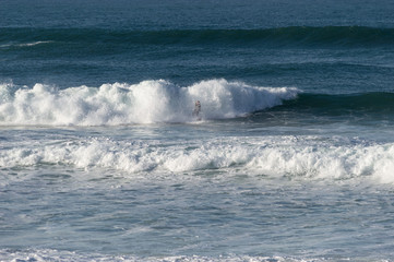 Sport surfing on the beach of zurriola located in san sebastian spain