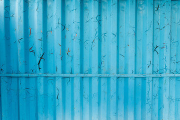 Metal curly sheets are painted in sky-blue color, old cracked paint. Abstract grunge texture.