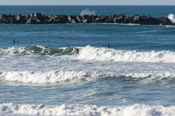 Sport surfing on the beach of zurriola located in san sebastian spain