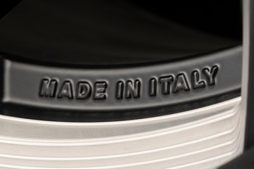 made in Italy-text on the rim of a cast aluminum wheel. Italian European production. auto parts and auto racing