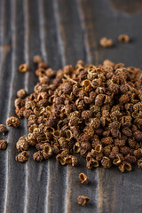 Sichuan pepper on a dark wooden rustic background