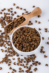 fragrant Sichuan pepper on white acrylic background