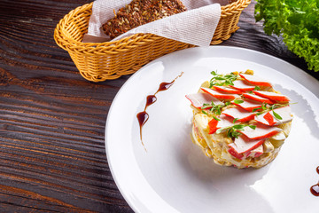 salad of fish sticks on dark wooden rustic background