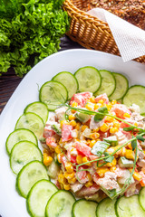 Fresh salad of vegetables and meat on wooden rustic background