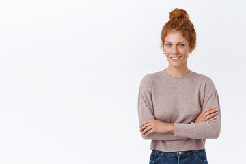 Confident, good-looking bossy female entrepreneur with red curly hair in stylish sweater, cross...