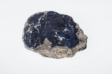 Chilean iridescent blue mineral with a copper in white background