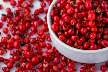 fragrant pink peppercorns on white acrylic background