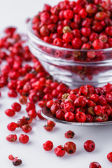 fragrant pink peppercorns on white acrylic background