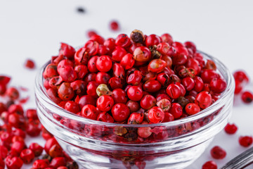 fragrant pink peppercorns on white acrylic background