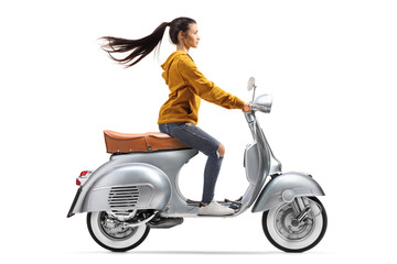 Obraz na płótnie Canvas Young female on a vintage scooter riding fast