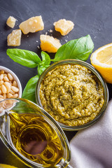 Delicious traditional italian pesto sauce on dark stone background
