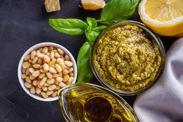 Delicious traditional italian pesto sauce on dark stone background