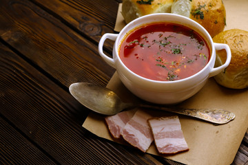 Composition with tasty traditional Bortshsch soup on wooden table
