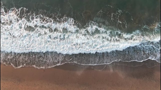 Looped seamless background from Sea tide with waves Green and orange colors with white foam