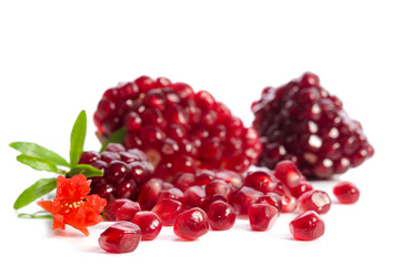 Parts of a pomegranate with pomegranate seeds and leaves, flowers isolated on white background