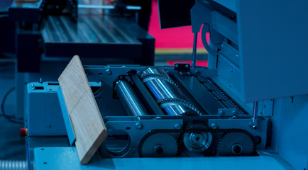 Close-up of a carpenter using a circular saw to cut a large board of wood