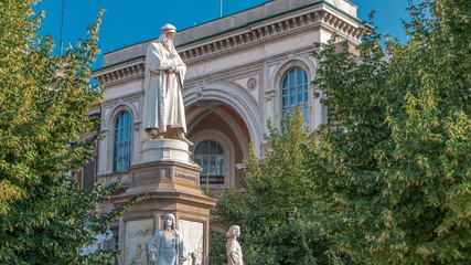 Fototapeta na wymiar Monument to Leonardo da Vinci in Piazza della Scala meaning La Scala square timelapse in Milan, Italy