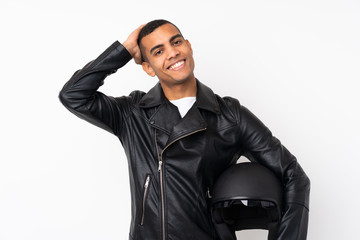 Young handsome man with a motorcycle helmet over isolated white background laughing