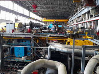 11.02.2020, Moldova, Chisinau: Power generator steam turbine in repair process, machinery, pipes, tubes, at power plant