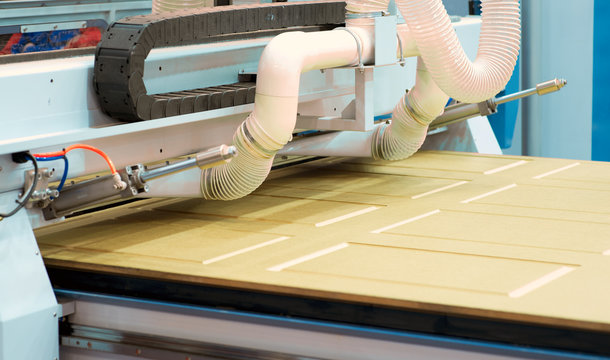 Milling a wooden board. Processing of wood panels on CNC coordinate milling woodworking machines. CNC woodworking machine.