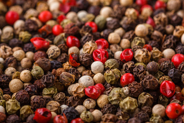 mix of peppercorns on white acrylic background