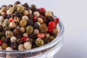 mix of peppercorns on white acrylic background