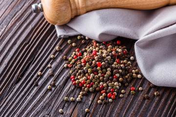 mix of peppercorns on a dark wooden rustic background