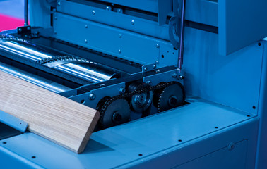 Close-up of a carpenter using a circular saw to cut a large board of wood