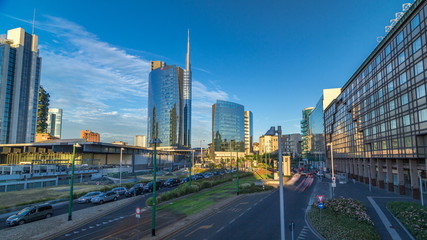 Fototapeta premium Milan skyline with modern skyscrapers in Porta Nuova business district timelapse in Milan, Italy, at sunset.