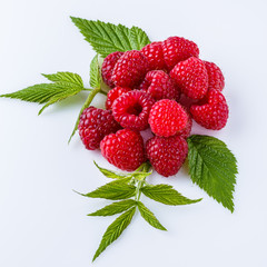 Juicy fresh natural raspberries on white acrylic background