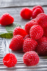 juicy fresh natural raspberries on a gray wooden rustic background