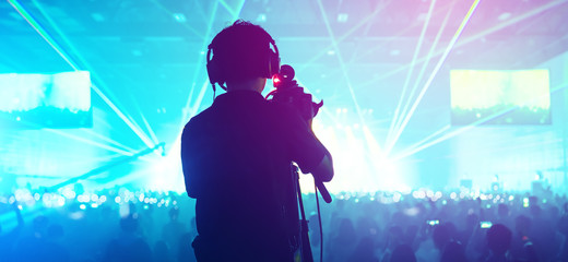 social media concept cameraman with crowd people  exitied moment in colorful lighting concert event...