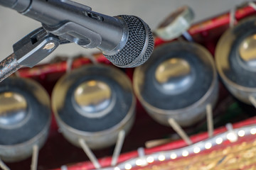 The microphone is ready for sound of a traditional musical instrument Khong Wong. Music performance at Buddhist temple, Thailand.