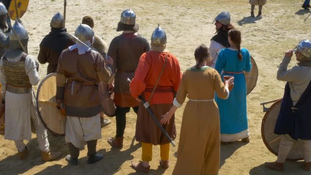 Middle Ages. Girls carry water in jugs for their warriors, quench their thirst before a fight.