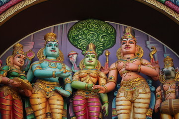 bright figures of the gods on the gopurama of a hindu temple in sri lanka