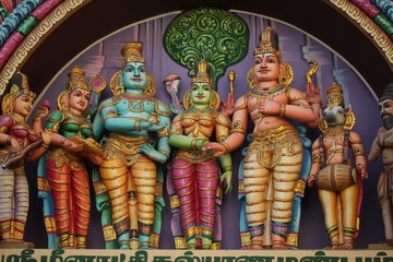 bright figures of the gods on the gopurama of a hindu temple in sri lanka