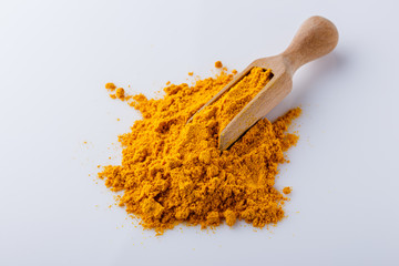natural turmeric powder on white acrylic background
