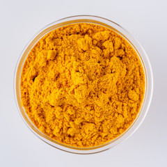 natural turmeric powder on white acrylic background