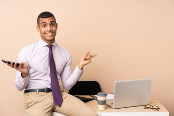 Young business man in a office pointing to the laterals having doubts