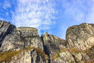 Preikestolen (also called Preachers Pulpit, Preachers Chair and Pulpit Rock) is a famous steep cliff with a flat plateau. View upwards from the water surface of the Lysefjord, a fjord in Norway