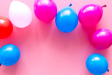 Decorative frame with colorful balloons on pink background top-down frame copy space