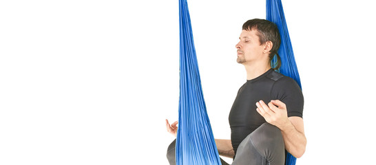 Male person do hammock yoga class exercise. Meditation in air clam. Aero beginner studio workout. Man lifestyle. Guy training zen pose. Horizontal banner with copy space