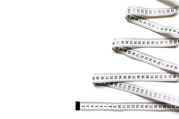 The figure is spiral of a centimeter tape. Isolate measuring tape on a white background.