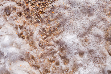 Sea foam ashore from small shells