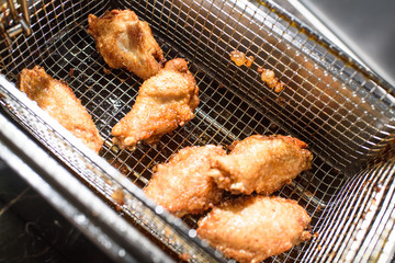 Freshly prepared grilled wings in a grill stove. Fatty food. Tasty food.