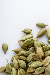 fragrant green cardamom on a white acrylic background