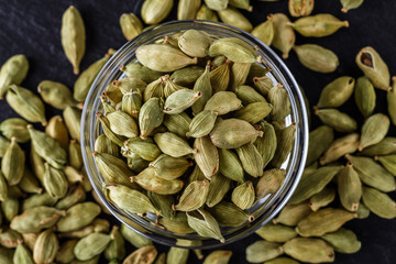 fragrant green cardamom on a dark stone background
