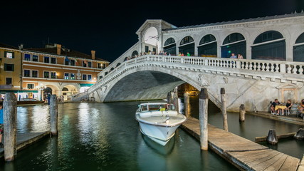 Fototapeta na wymiar Rialto Bridge or Ponte di Rialto over Grand Canal timelapse at night in Venice, Italy.