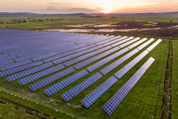 Blue solar photo voltaic panels system producing renewable clean energy on rural landscape and...