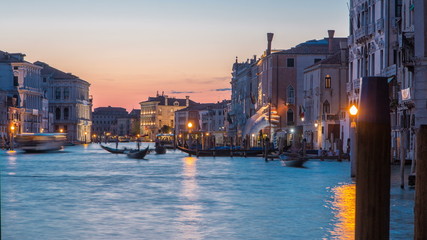 View of the Grand canal near Rialto Market day to night timelapse after sunset, Venice, Italy viewed from pier